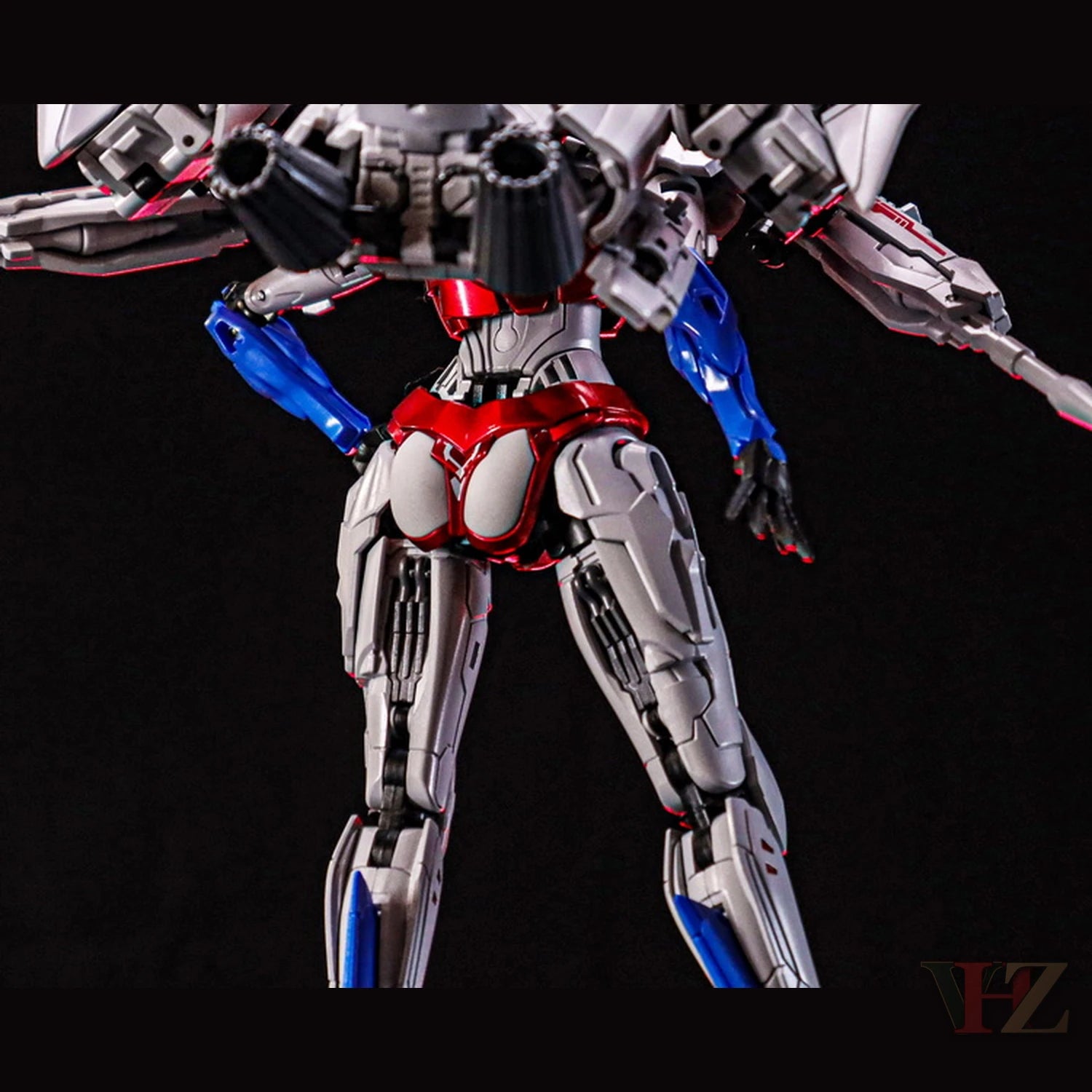 Back view of Collection Space CS-03 Starqueen Starscream mecha girl figure, silver and red body, blue arm details, mechanical legs against black background.